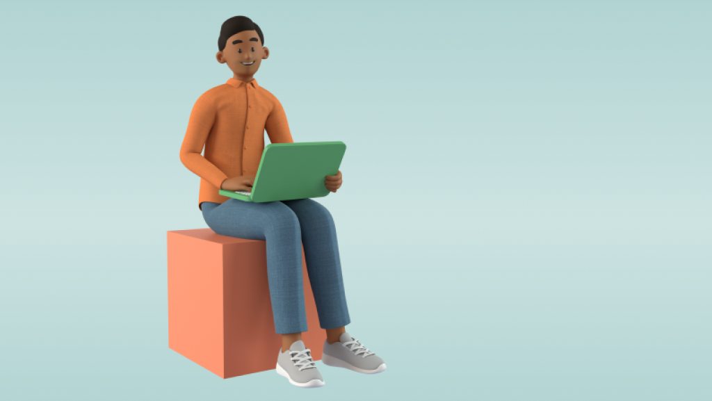 Mann med orange genser sitter på en blokk og holder en laptop