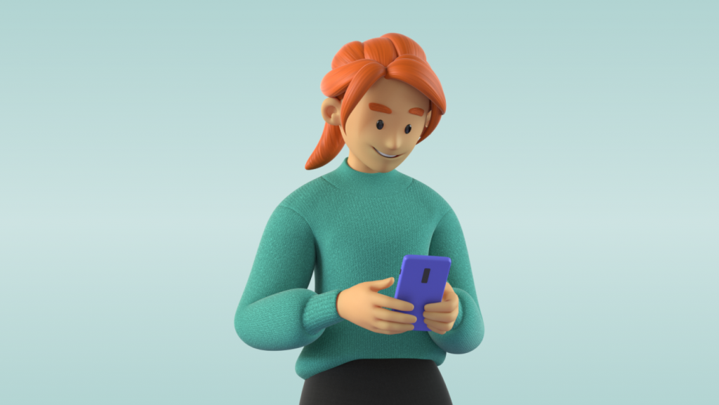 Kvinne i grønn genser ser ned på mobiltelefonen i hendene sine