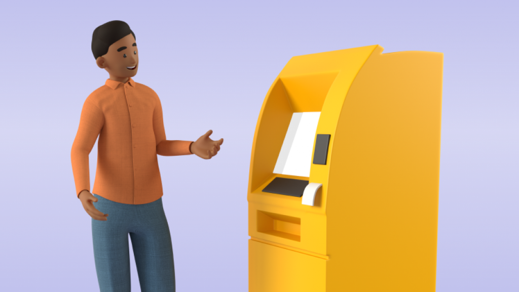 Man in an orange shirt standig next to a yellow self-service machine with one hand raised and palm up